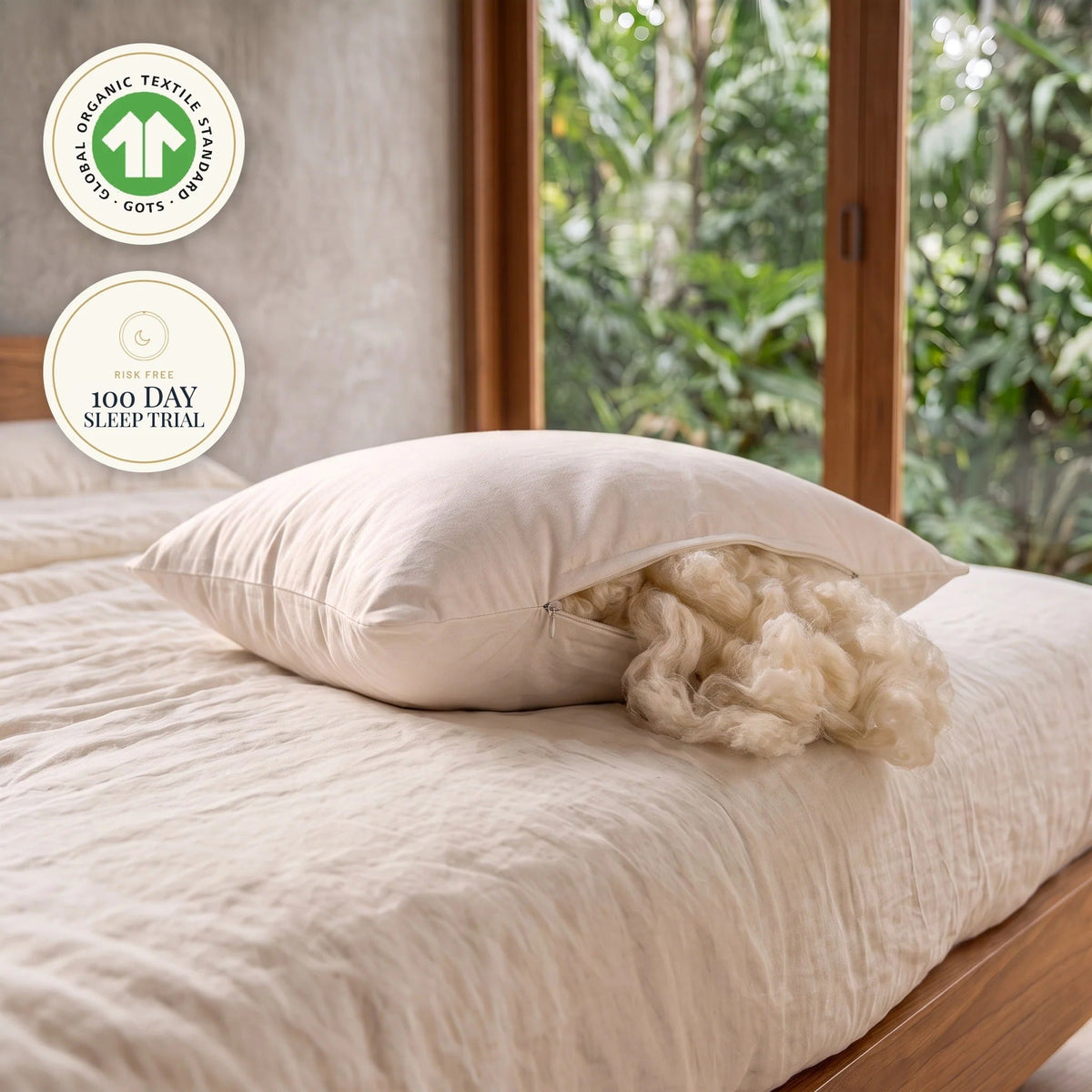 MAREA kapok pillow with its zipper open and silky wild harvested kapok fiber spilling out, the fill on its own with nothing blended in